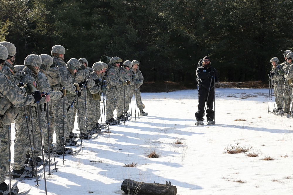 Cold-Weather Operations Course Class 18-05 students practice snowshoeing at Fort McCoy