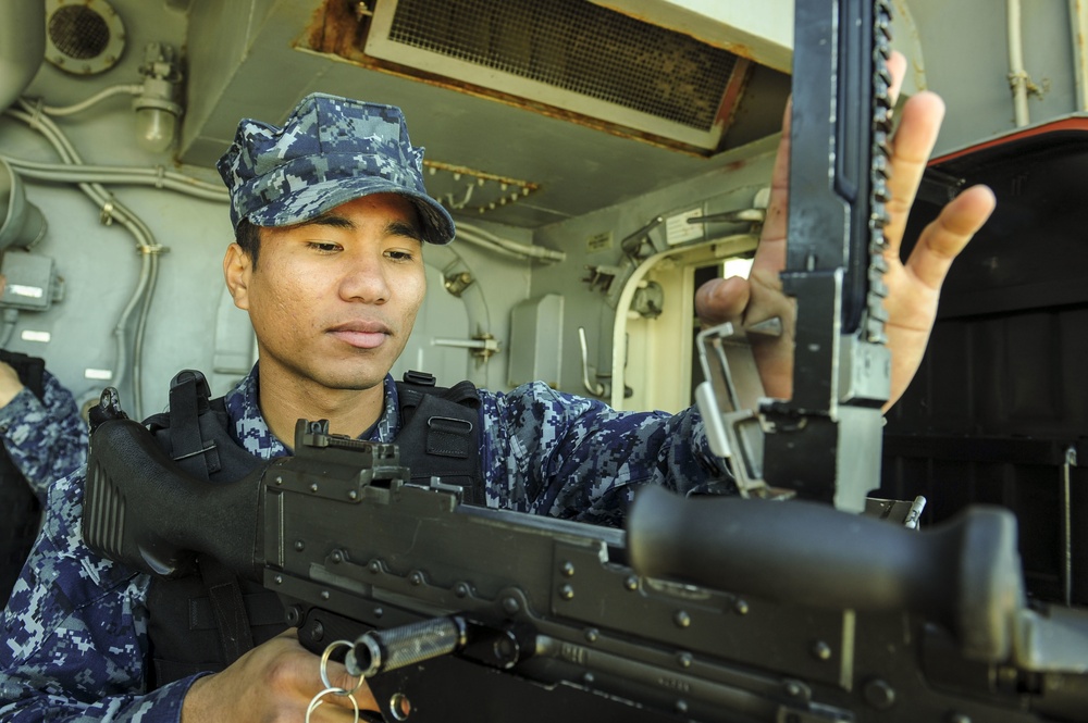 USS America Sailor inspects machine gun