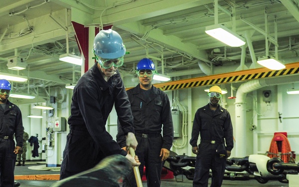 USS America Sailor detaches pelican hook