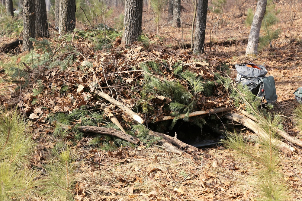 Cold-Weather Operations Course Class 18-05 students build improvised shelters at Fort McCoy