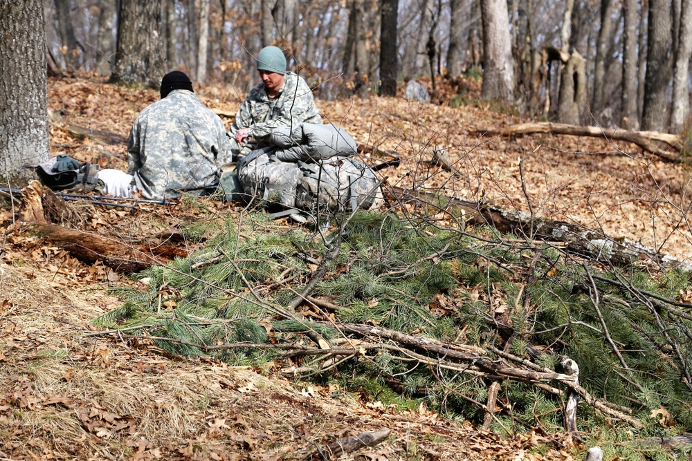 Cold-Weather Operations Course Class 18-05 students build improvised shelters at Fort McCoy