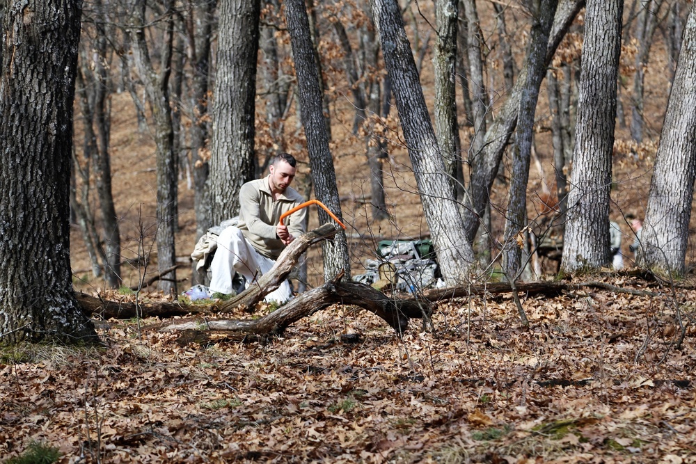 Cold-Weather Operations Course Class 18-05 students build improvised shelters at Fort McCoy