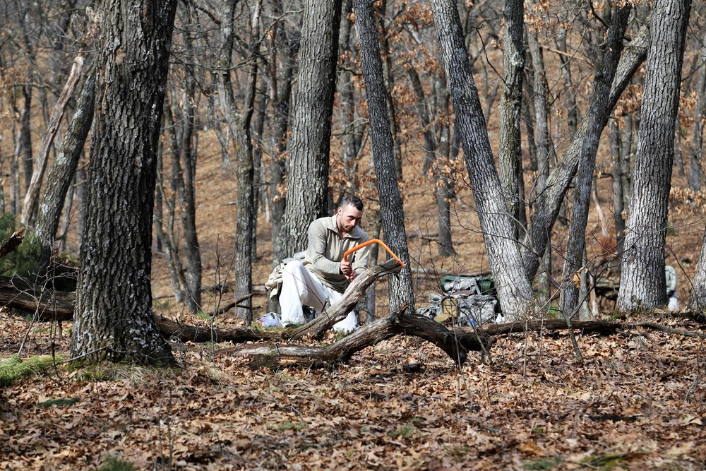 Cold-Weather Operations Course Class 18-05 students build improvised shelters at Fort McCoy