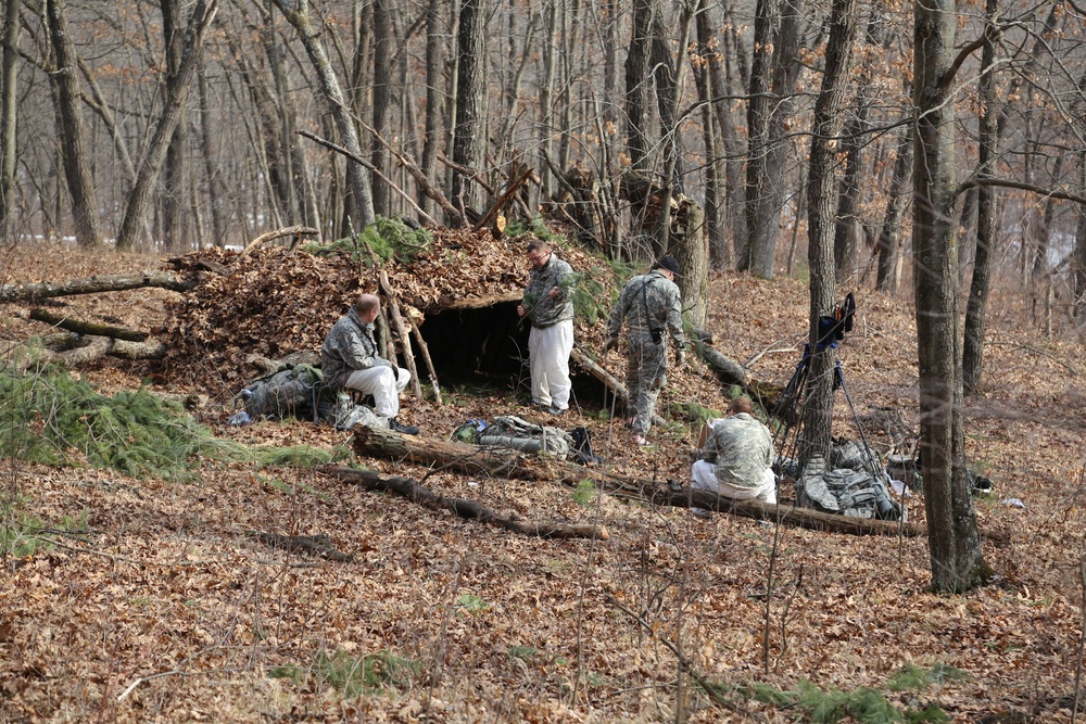 Cold-Weather Operations Course Class 18-05 students build improvised shelters at Fort McCoy