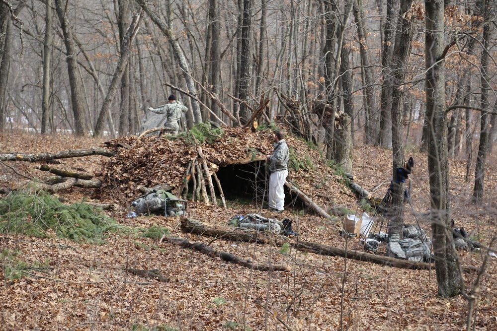 Cold-Weather Operations Course Class 18-005 students build improvised shelters at Fort McCoy