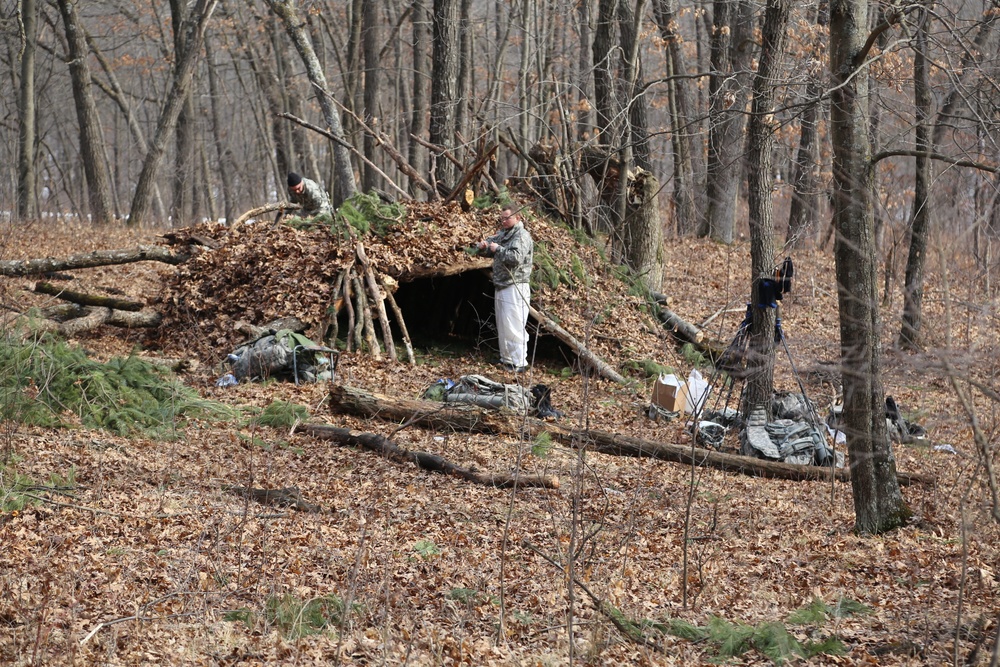 Cold-Weather Operations Course Class 18-05 students build improvised shelters at Fort McCoy