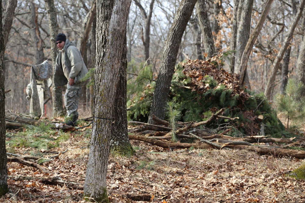 Cold-Weather Operations Course Class 18-05 students build improvised shelters at Fort McCoy