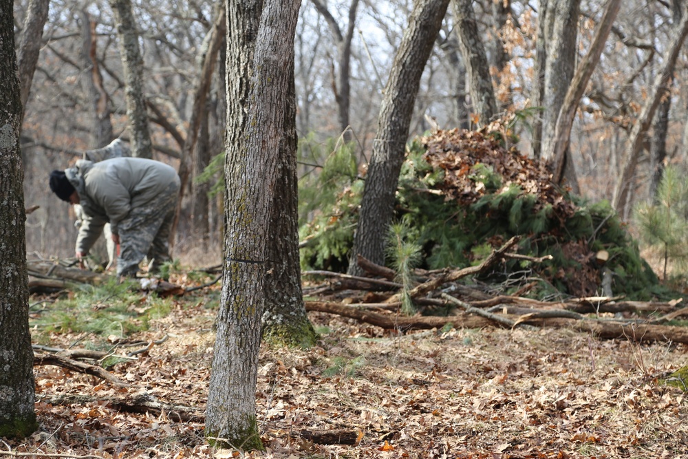 Cold-Weather Operations Course Class 18-05 students build improvised shelters at Fort McCoy