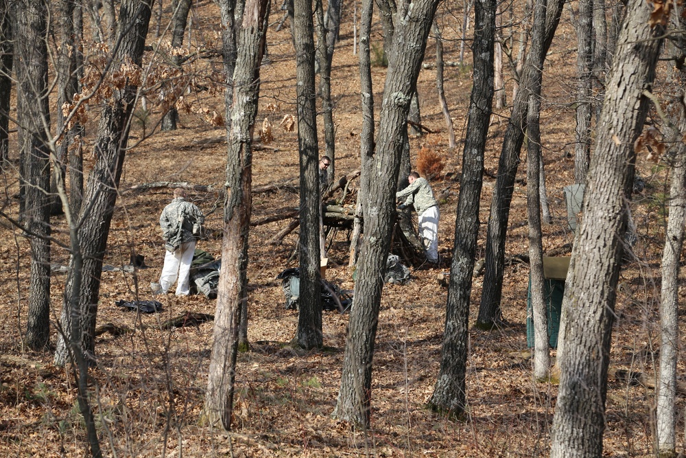 Cold-Weather Operations Course Class 18-05 students build improvised shelters at Fort McCoy