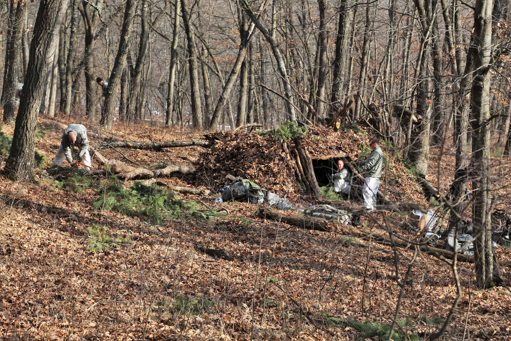 Cold-Weather Operations Course Class 18-05 students build improvised shelters at Fort McCoy