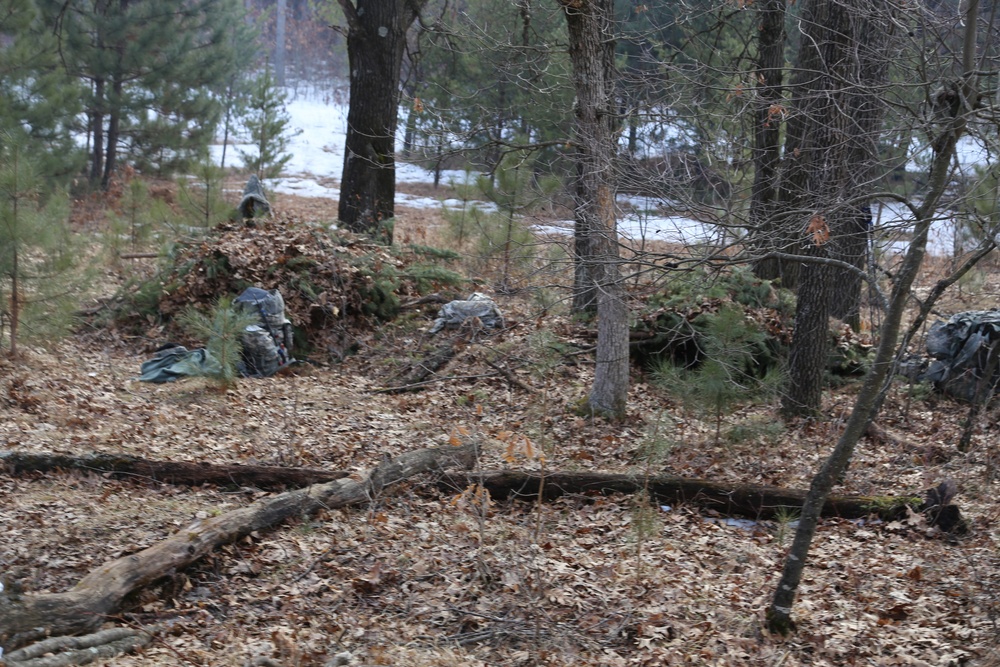 Cold-Weather Operations Course Class 18-05 students build improvised shelters at Fort McCoy