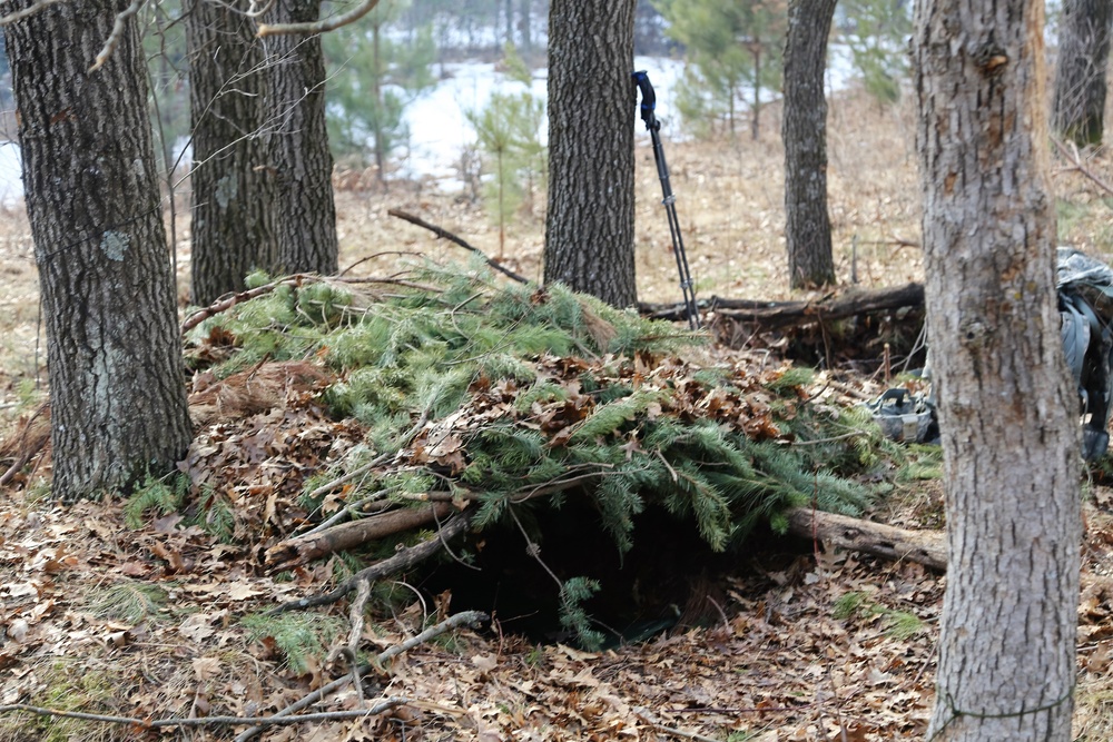 Cold-Weather Operations Course Class 18-05 students build improvised shelters at Fort McCoy