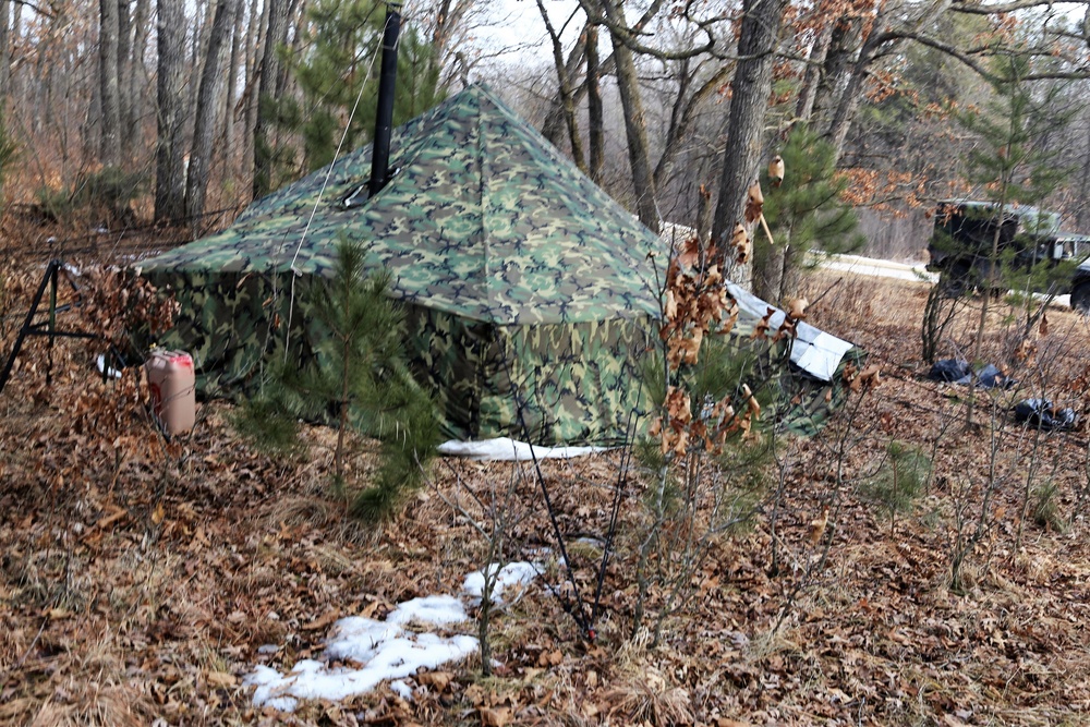 Cold-Weather Operations Course Class 18-05 students build improvised shelters at Fort McCoy