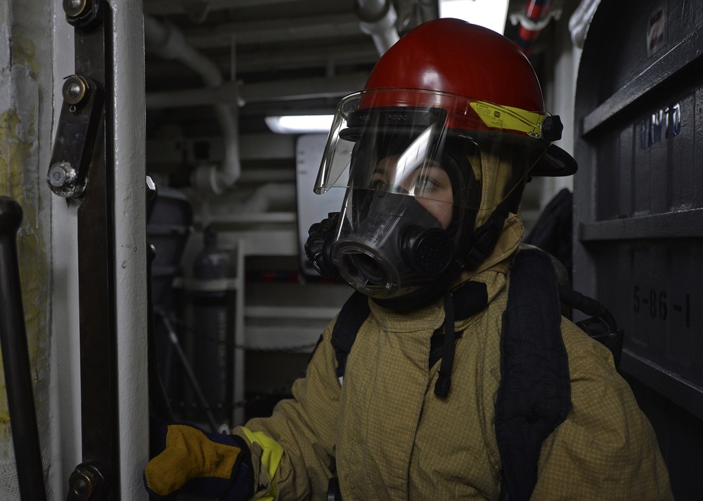 Sailors train during a main space fire drill.