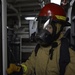 Sailors train during a main space fire drill.