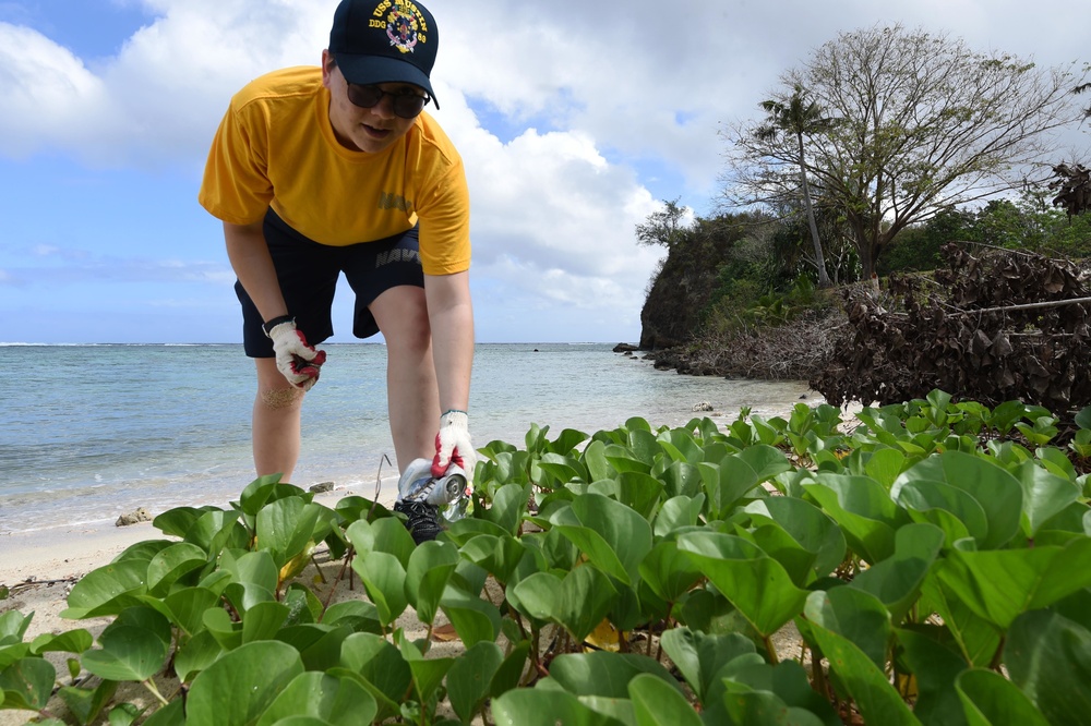 USS Mustin Sailor cleans up debris from Asan-Ma’ina beach in Guam during MultiSail 18.