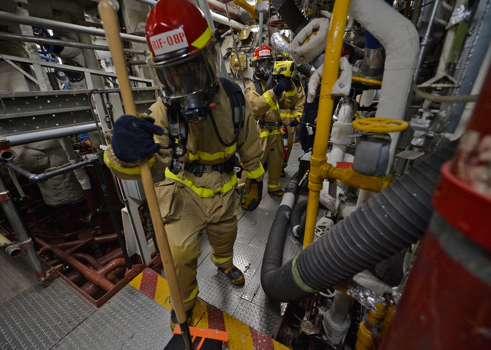 Sailors train during a main space fire drill.