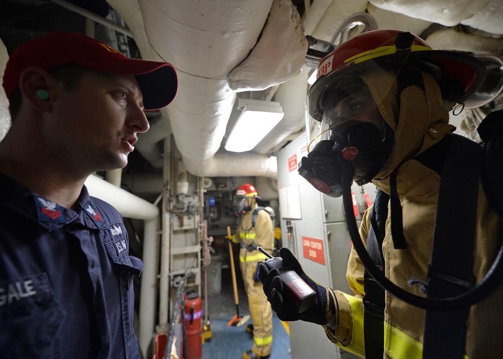 Sailors train during a main space fire drill.