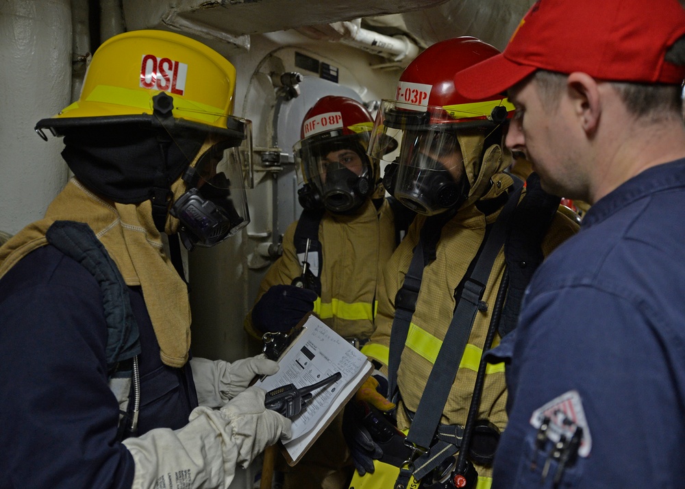 Sailors train during a main space fire drill.