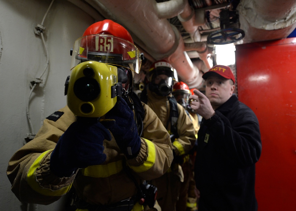 Sailors train during a main space fire drill.