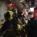 Sailors train during a main space fire drill.