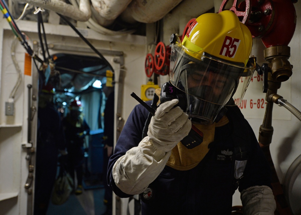 Sailors train during a main space fire drill.