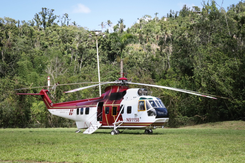 A helicopter moves personnel from the Aguadilla Area Office to a worksite in Lares