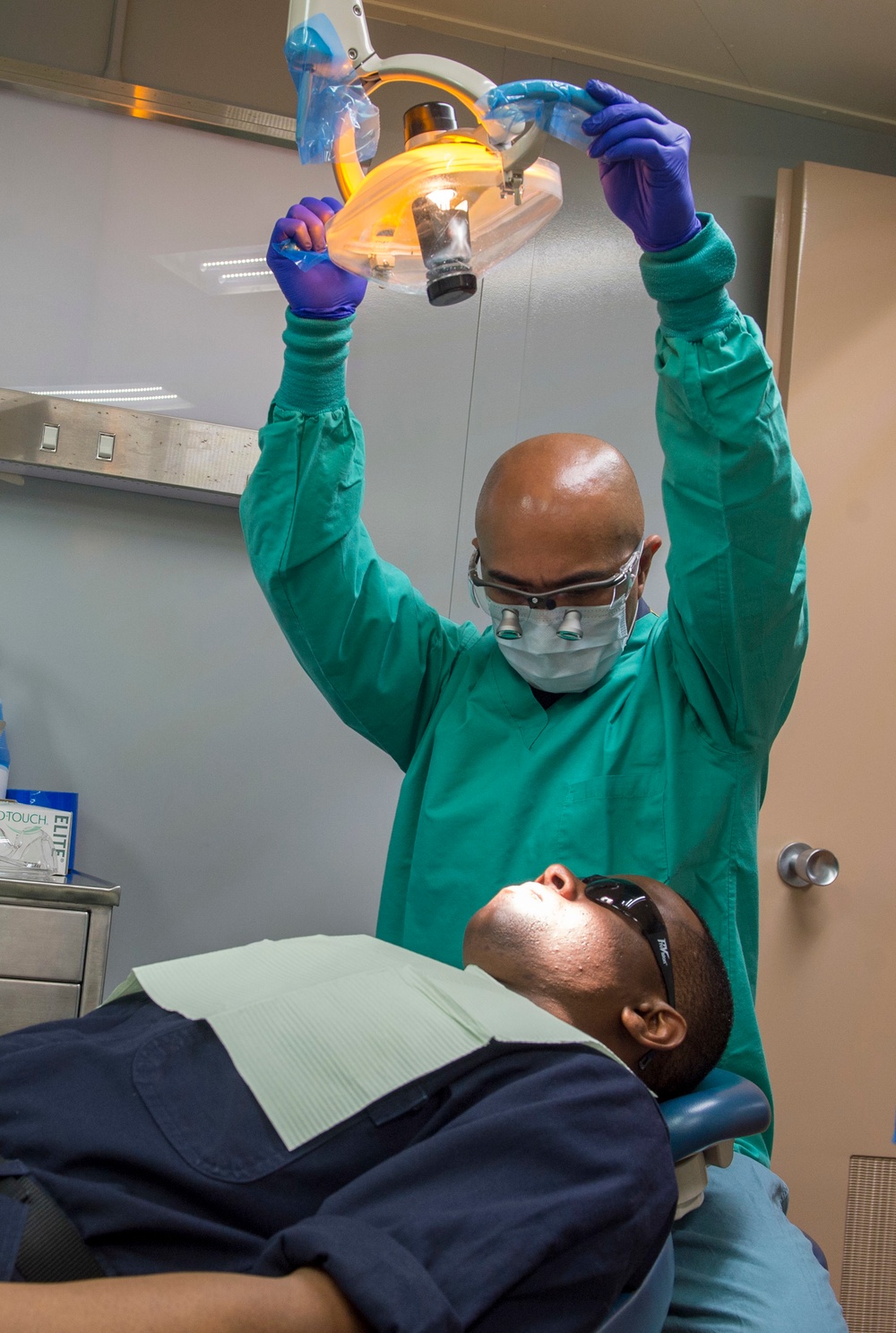 Sailors conduct a dental exam aboard USNS Mercy