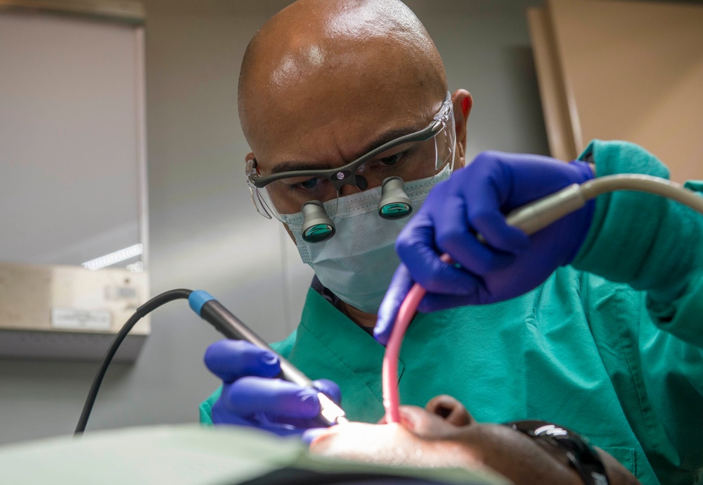 Sailors conduct a dental exam aboard USNS Mercy