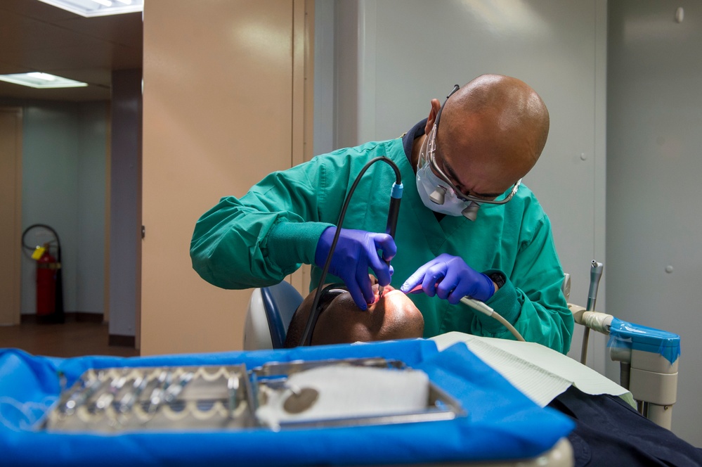 Sailors conduct a dental exam aboard USNS Mercy