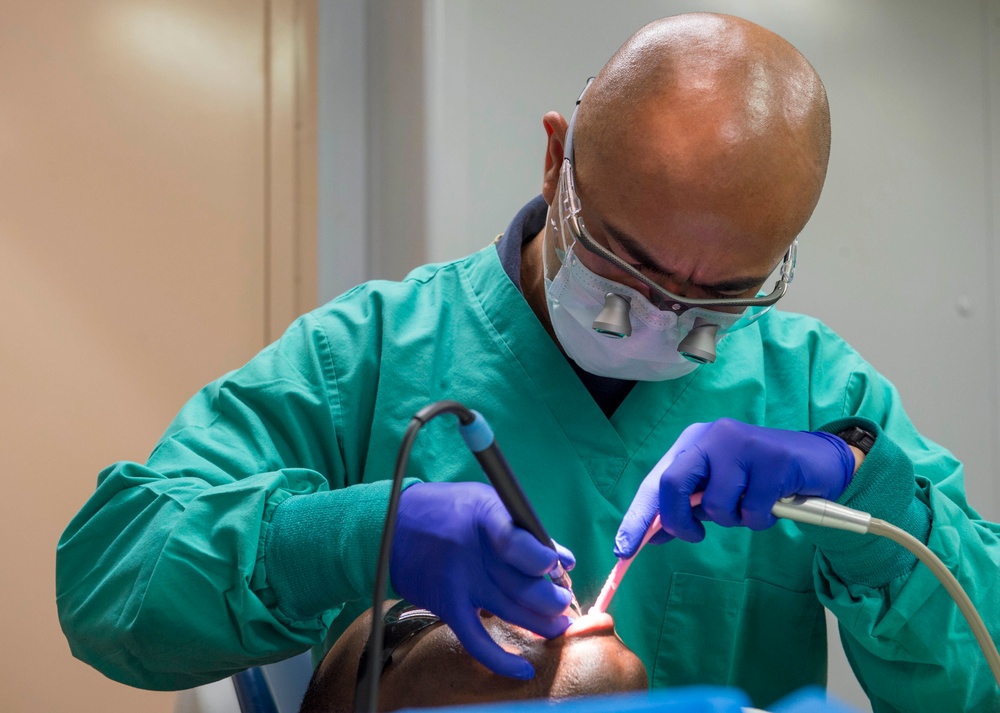 Sailors conduct a dental exam aboard USNS Mercy