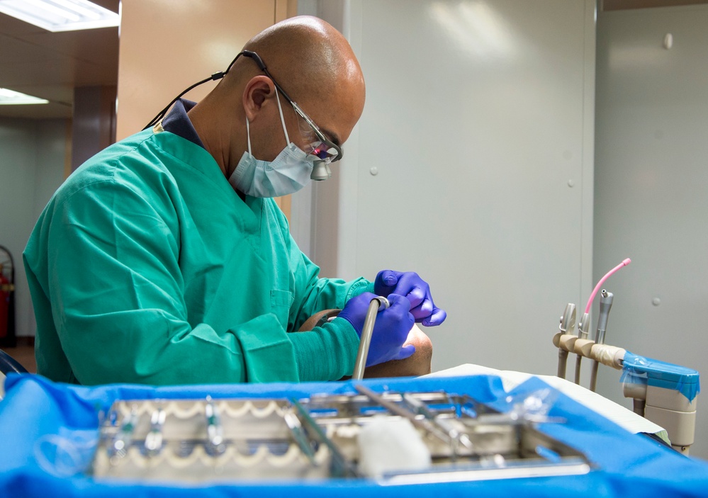 Sailors conduct a dental exam aboard USNS Mercy