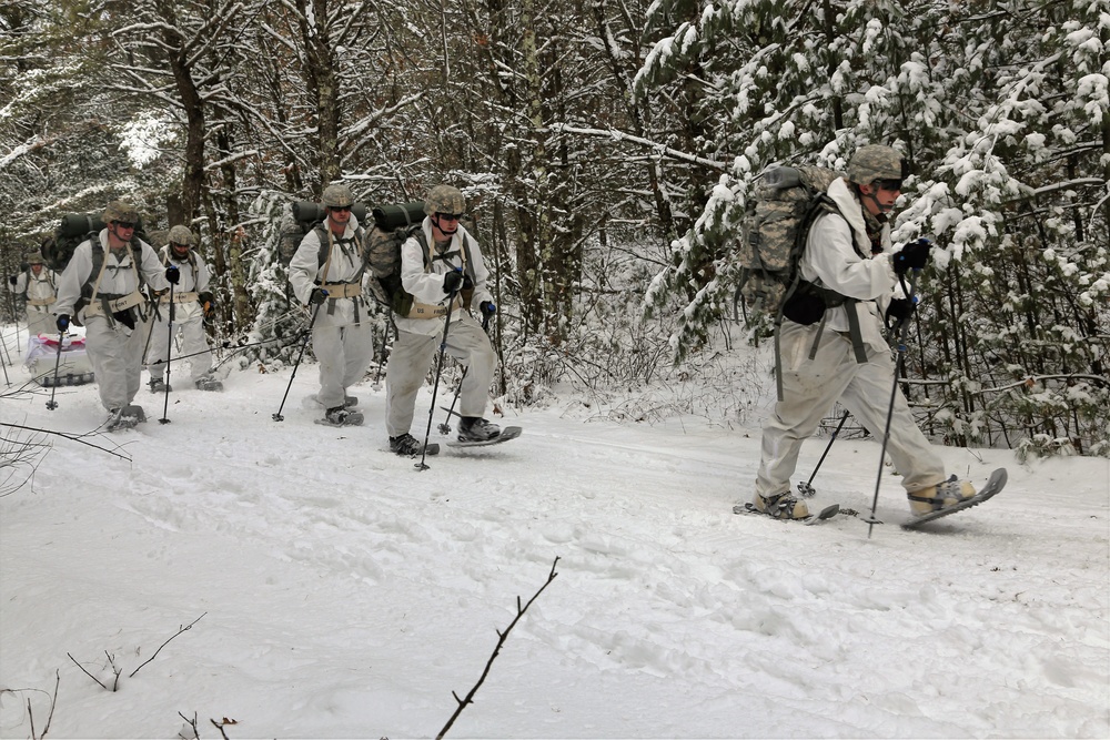 Cold-Weather Operations Course Class 18-06 students practice snowshoeing at Fort McCoy