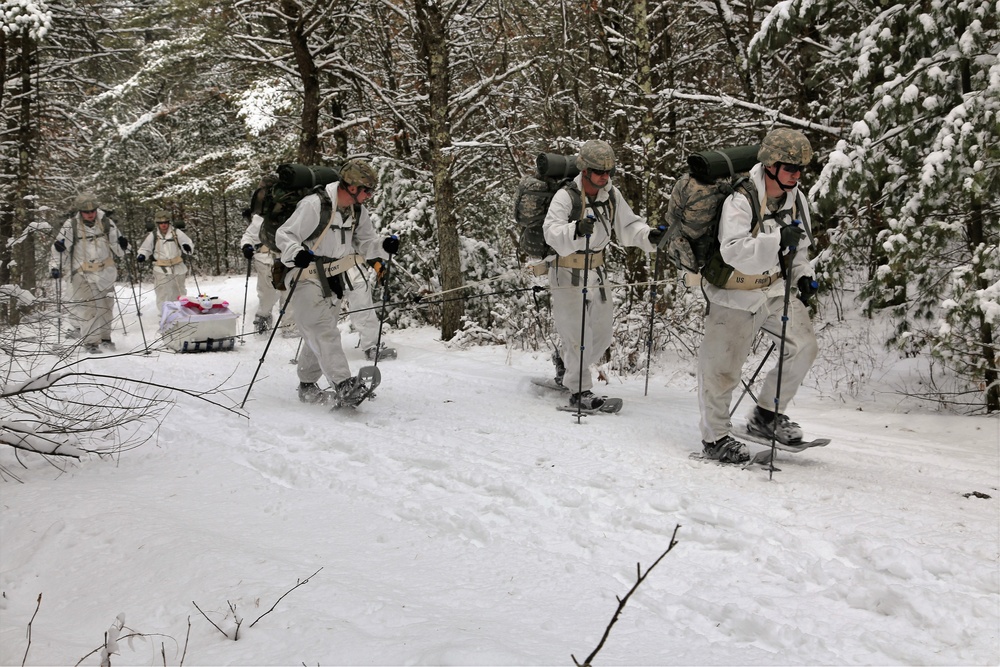 Cold-Weather Operations Course Class 18-06 students practice snowshoeing at Fort McCoy