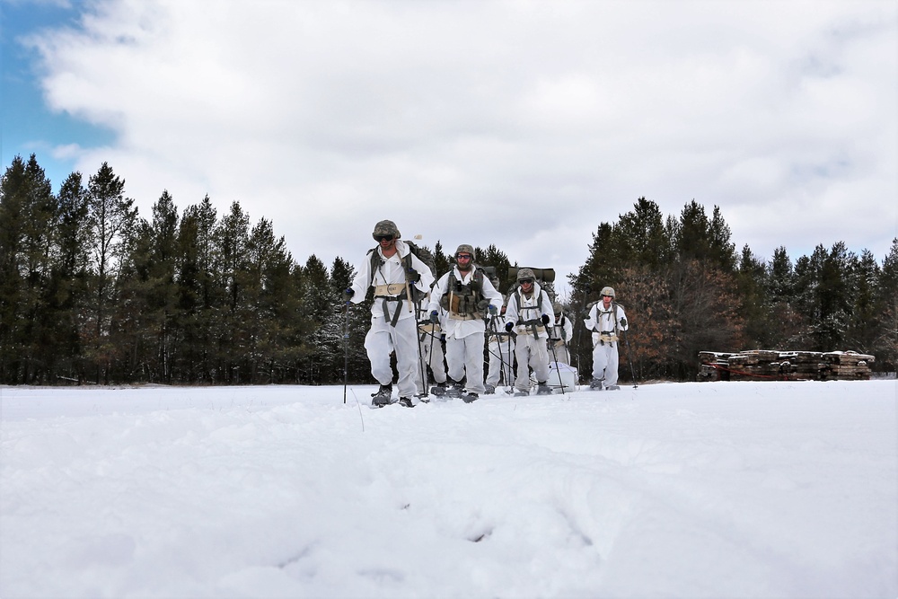 Cold-Weather Operations Course Class 18-06 students practice snowshoeing at Fort McCoy