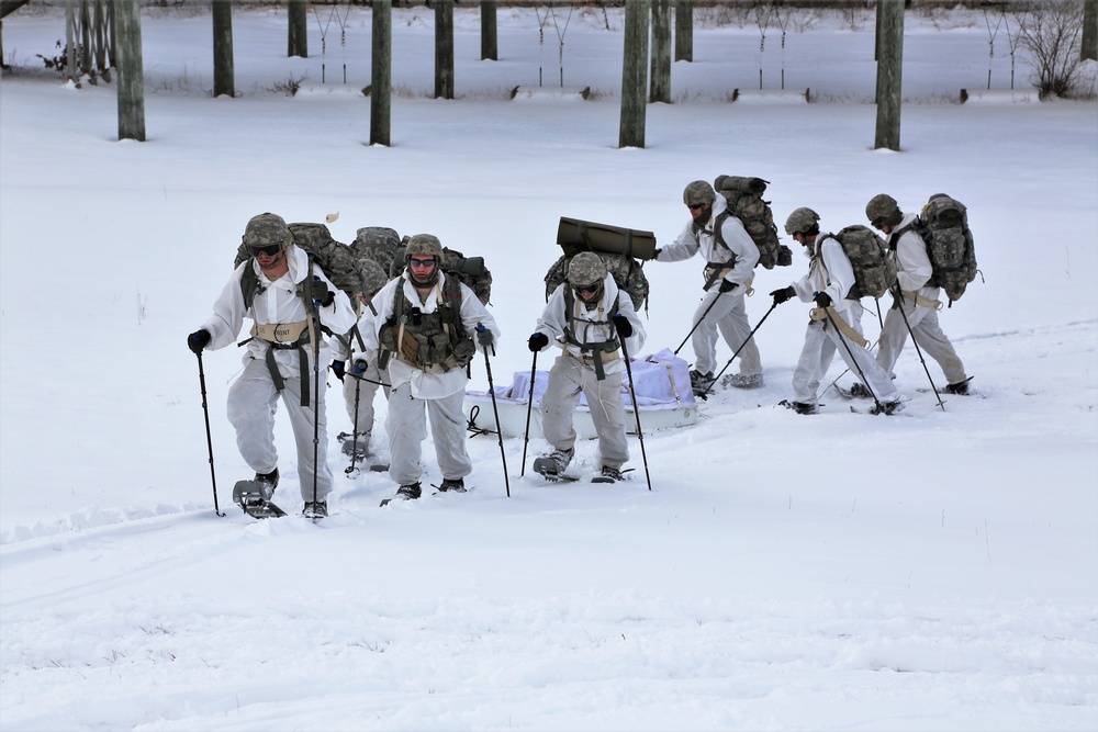 Cold-Weather Operations Course Class 18-06 students practice snowshoeing at Fort McCoy