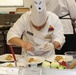 Apprentice Chef Pvt. First Class Kevin Rodriguez First Cavalry Division Culinary Team assists his lead Chef by seasoning preparations