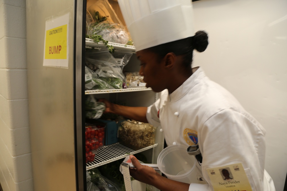 Pvt. Naya Pender U.S. Army Europe Culinary Team assists her lead Chef by dry storage preparations