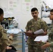Medical personnel discuss MASCAL procedures during exercise