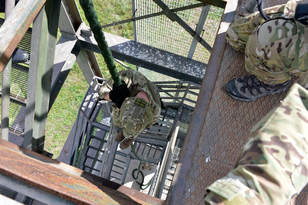 British Royal Marine commandos fast rope with SPMAGTF-CR-AF Marines