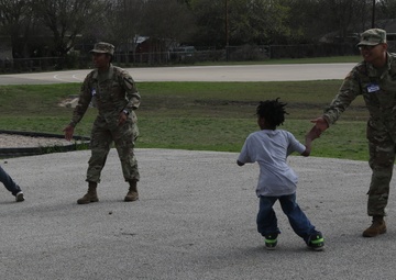 Heavy Truck soldiers educate, entertain children at adopted school