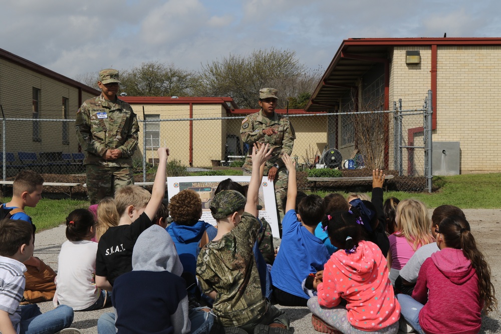 Heavy Truck soldiers educate, entertain children at adopted school