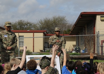 Heavy Truck soldiers educate, entertain children at adopted school