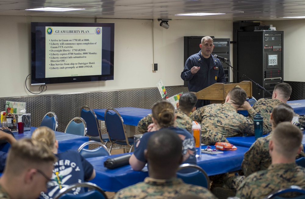 Sailors aboard USNS Mercy attend a port brief