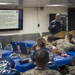 Sailors aboard USNS Mercy attend a port brief