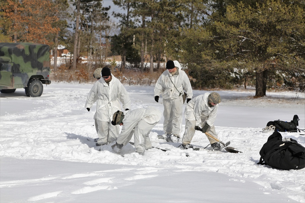 Cold-Weather Operations Course Class 18-06 students build Arctic tents during training at Fort McCoy