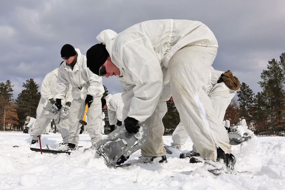 Cold-Weather Operations Course Class 18-06 students build Arctic tents during training at Fort McCoy