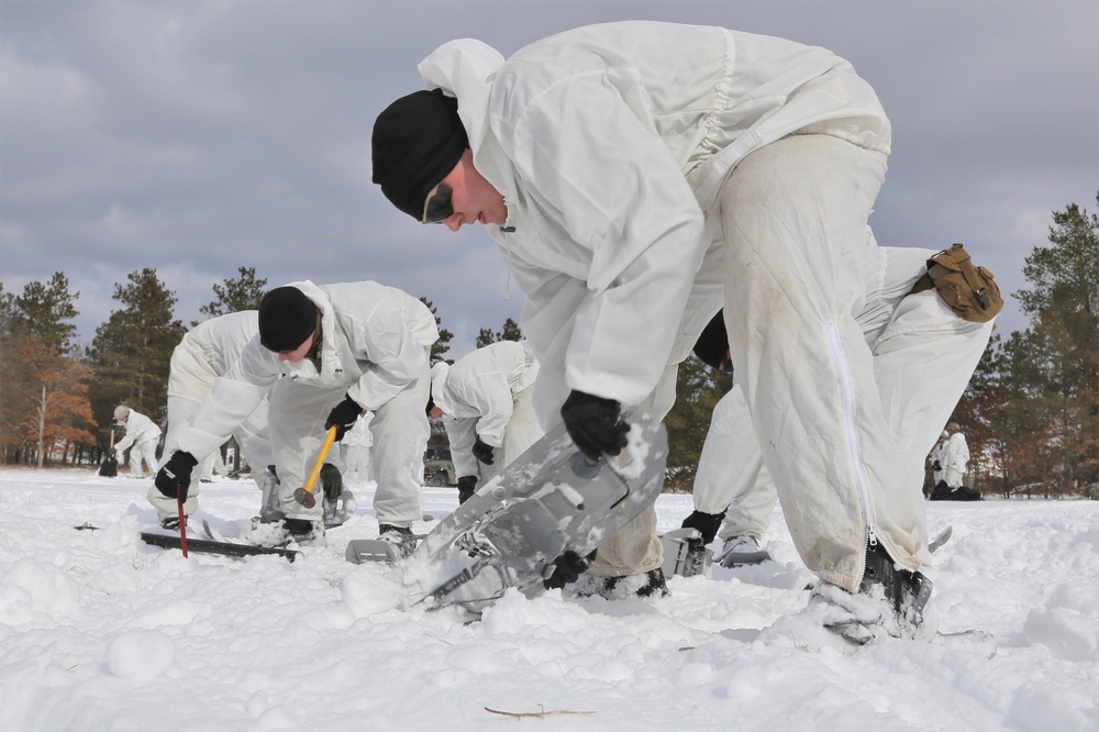 Cold-Weather Operations Course Class 18-06 students build Arctic tents during training at Fort McCoy