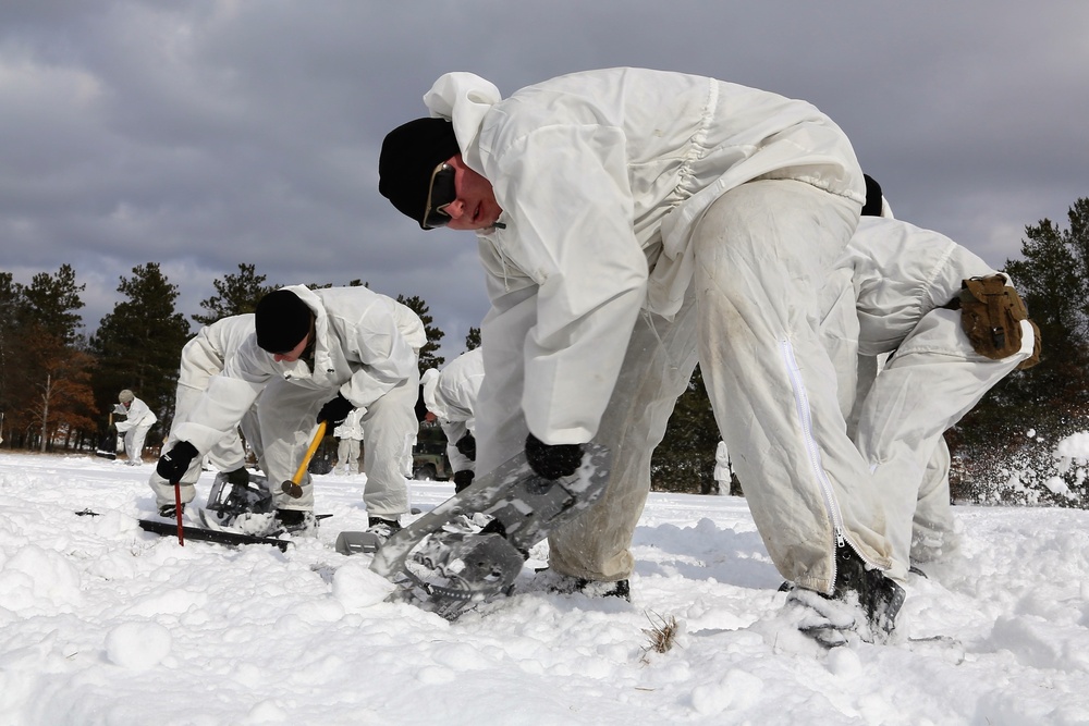 Cold-Weather Operations Course Class 18-06 students build Arctic tents during training at Fort McCoy