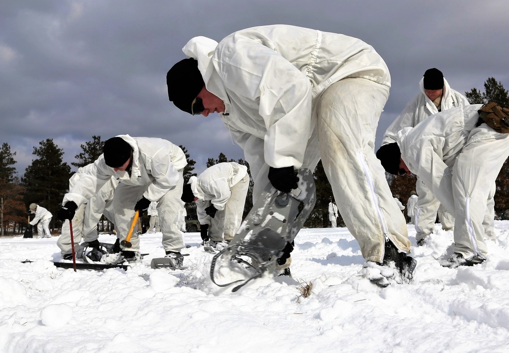 Cold-Weather Operations Course Class 18-04 students build Arctic tents during training at Fort McCoy